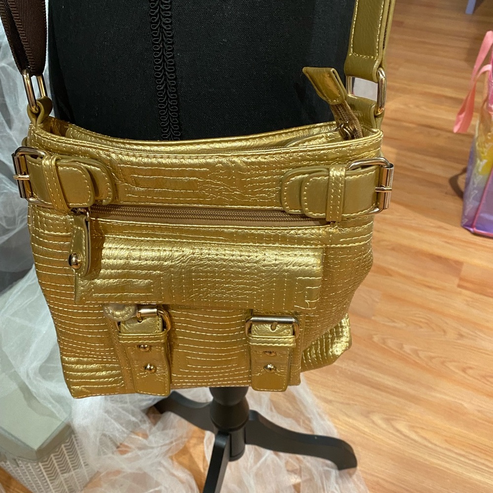 Gold cross bag with brown strap never used